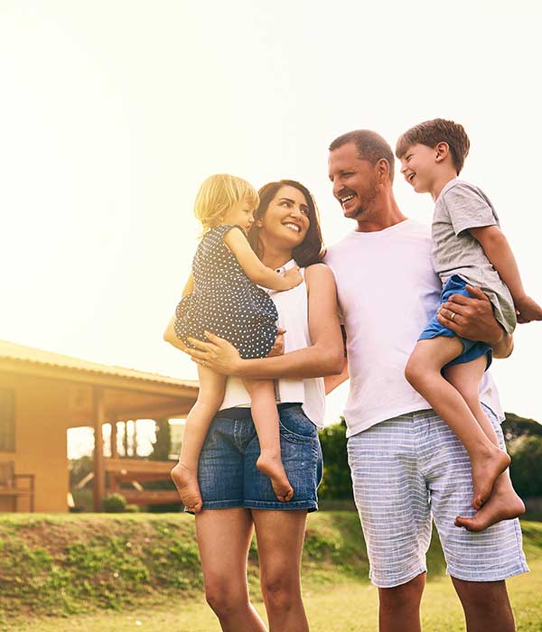 happy family in front of house